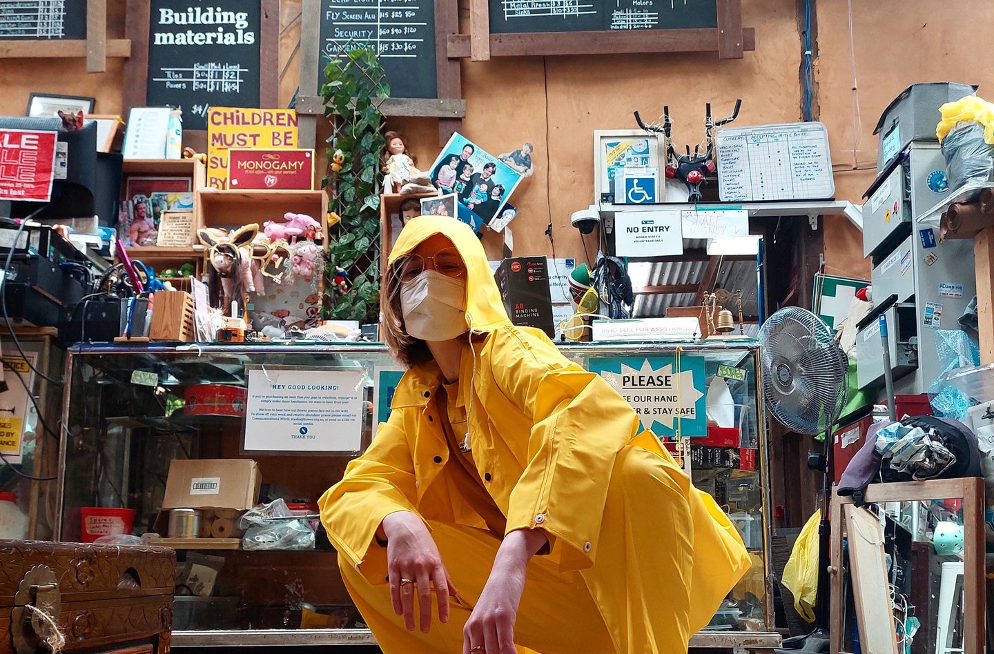 A person wearing a yellow jacket at a recycling centre in Sydney